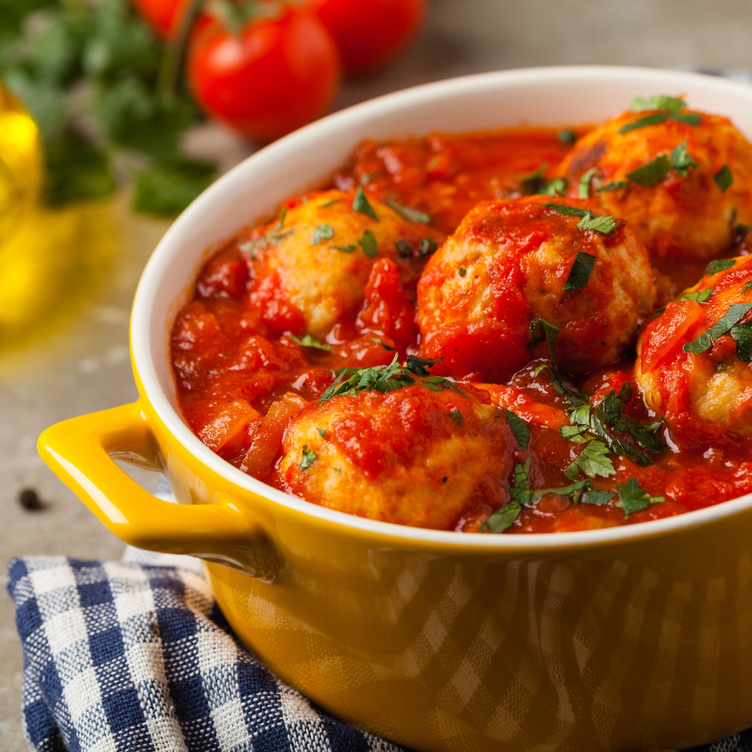 Chicken meatballs with tomato sauce. Served with rice. Front view. Stone background.